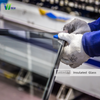 Factory Worker Inspecting Insulated Glass Edge Sealing Quality