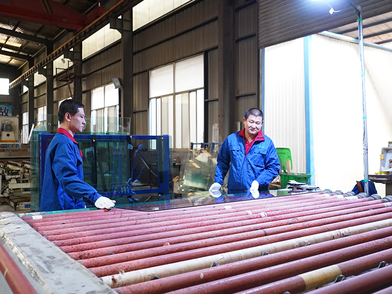 Experienced architectural glass production team working in factory